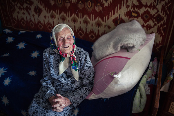 Elizaveta Lakeyeva sits on her bed.