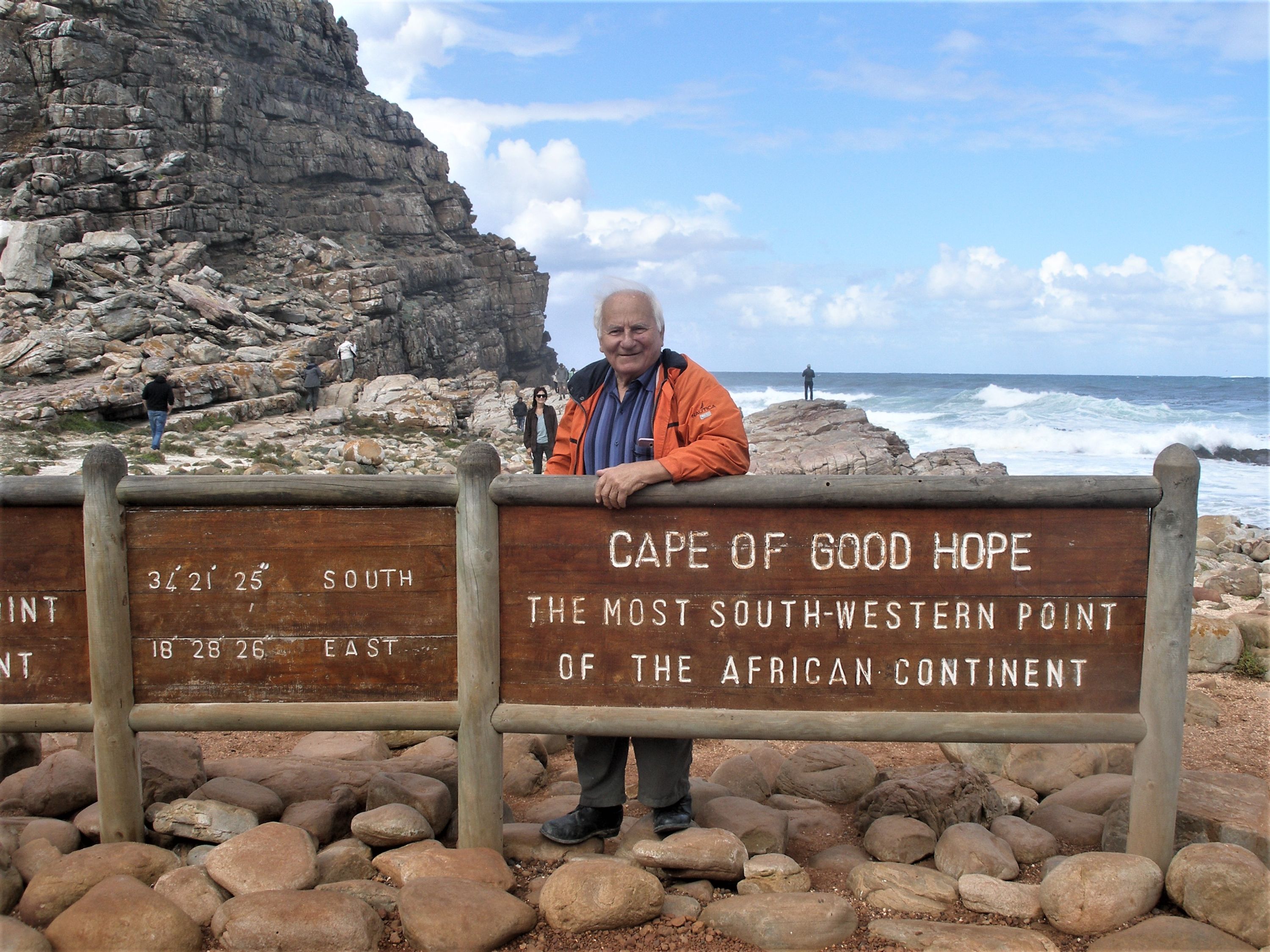 Man standing at Cape of Good Hope sign.