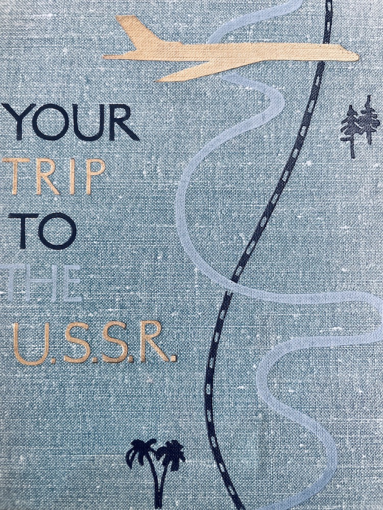 A cover of the book Your Trip to the U.S.S.R.. It is tea with a cartoon road, pine tree, palm tree, and airplane.