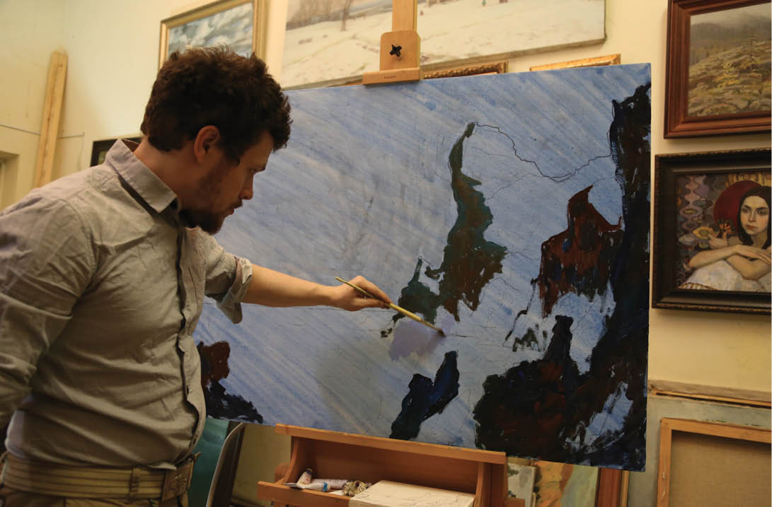 Dmitry painting in his studio in Moscow.