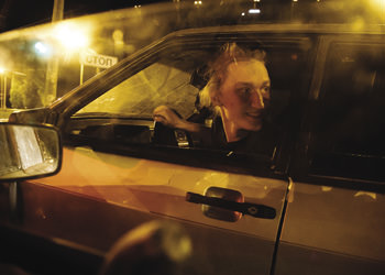 Man looking out car window.