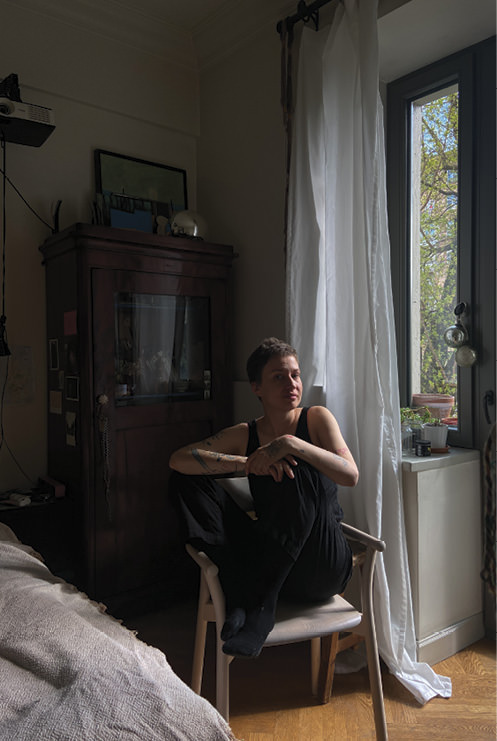 Woman sitting in a chair.