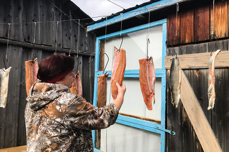 Yelena Kosinskaya inspects drying fish from the Amur, one of the village’s main products.