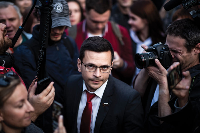 Man in crowd looking at camera.