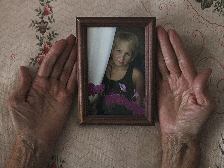 Nadya Stafeyeva's mother holds an old photo of her.