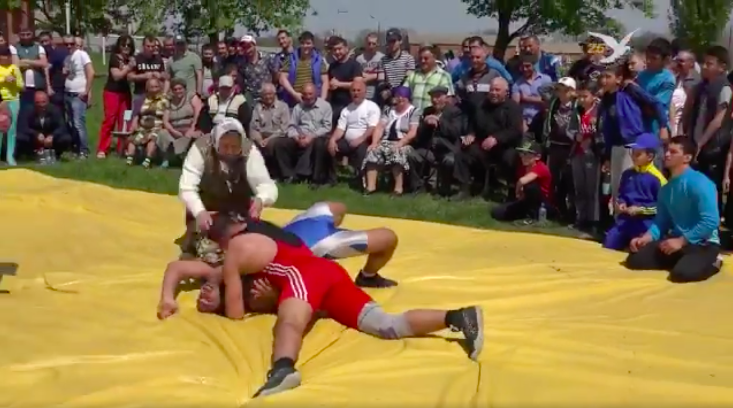 Babushka defending grandson in wrestling match