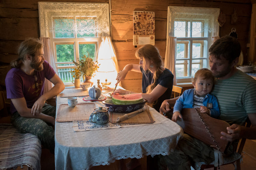 Family eating in log home.