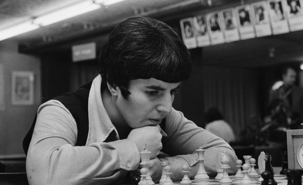 Woman staring at chess board