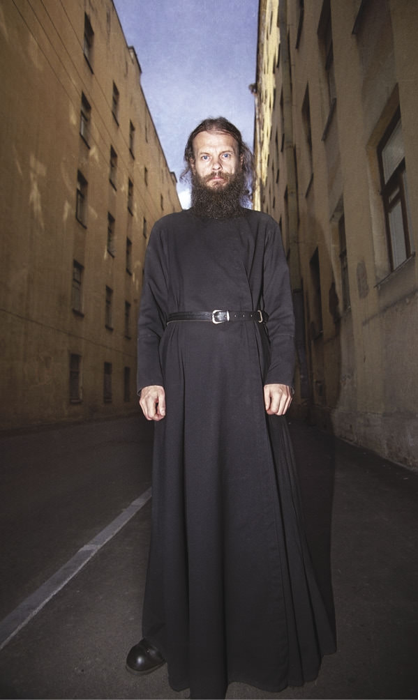 Man standing and looking ominously at the camera.