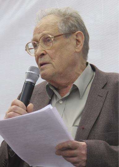 Man holding a microphone and speaking
