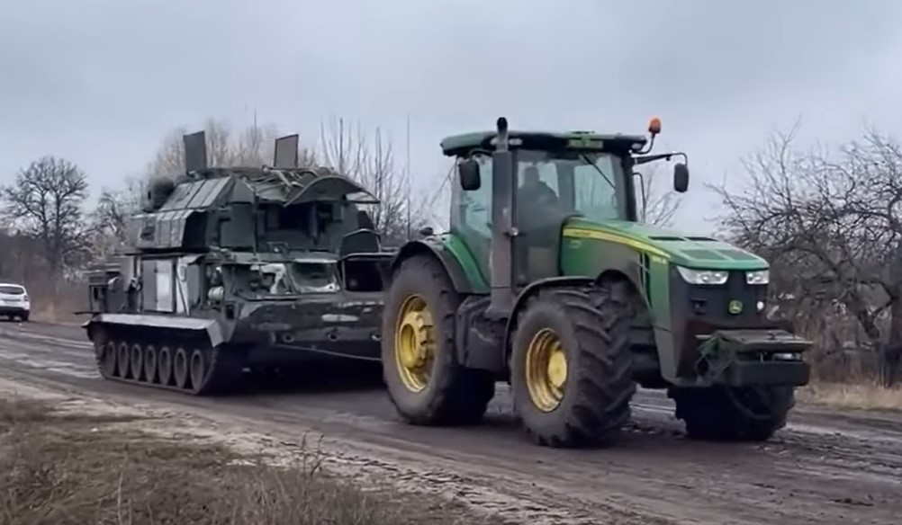 tractor pulling Russian milit equipment