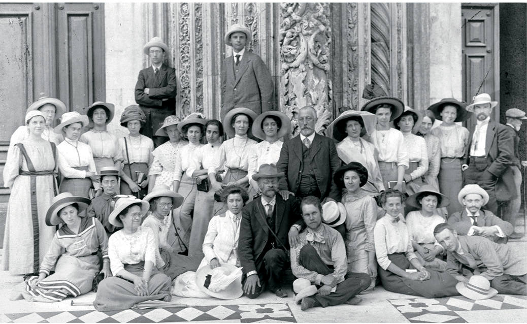 Women and one man posing in early 20th century for camera.