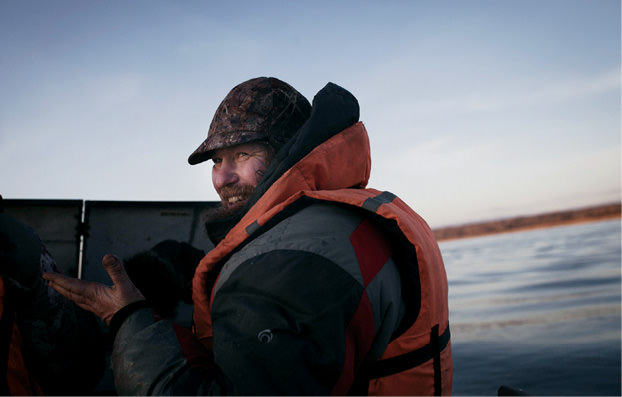 Priest driving a boat.