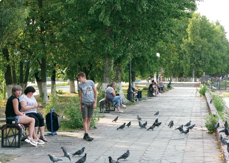 People relaxing on park benches.