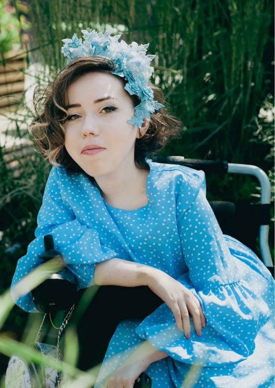 Woman in a wheelchair looking at the camera.