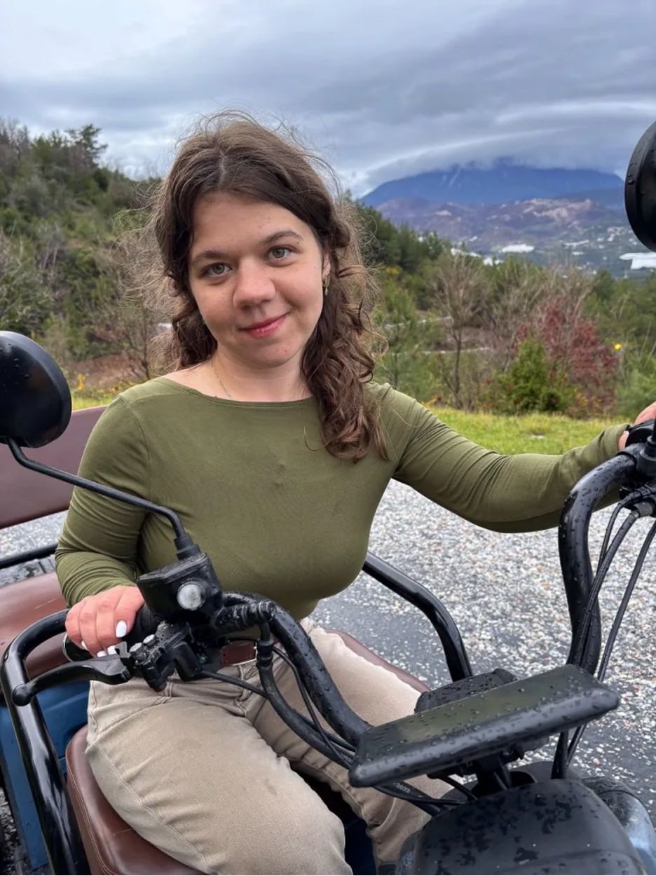 Woman on a wheelchair looking at the camera.