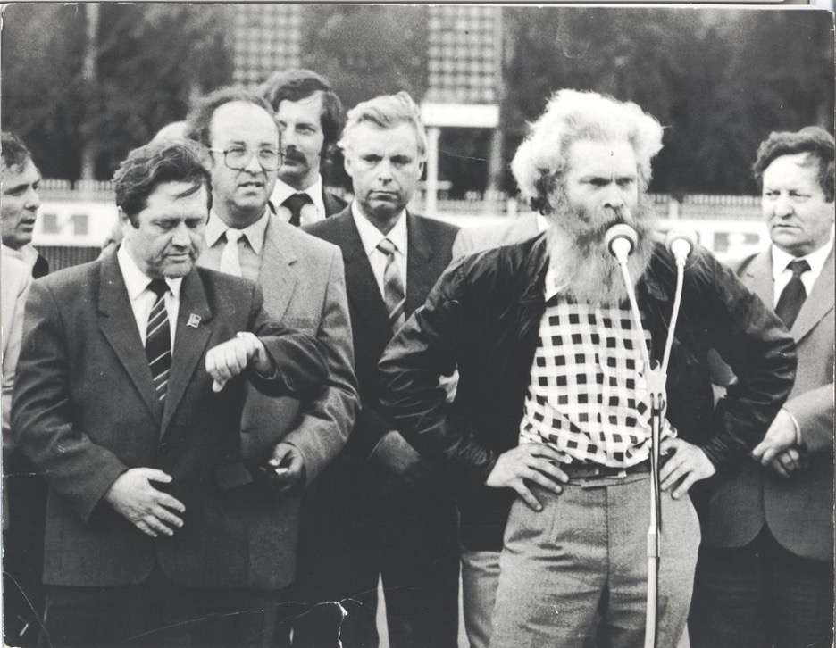 Men speaking into a microphone.