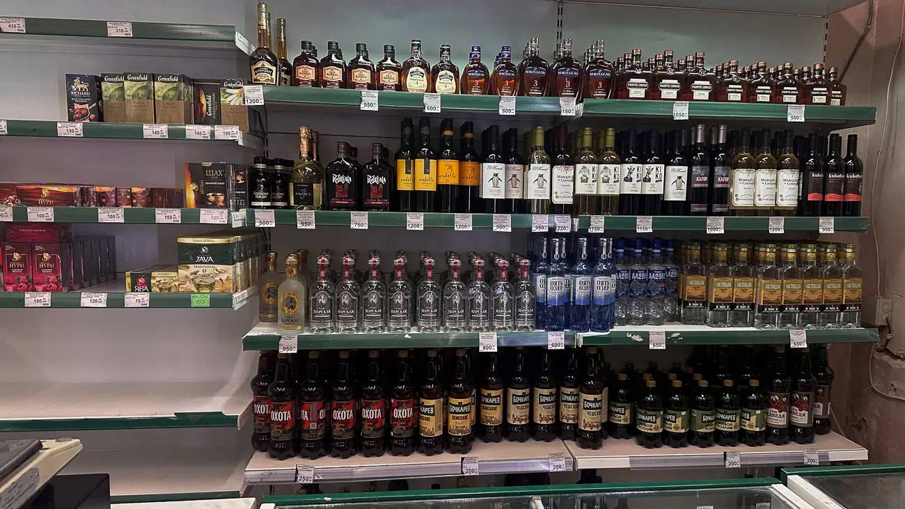 Shelves of alcohol in a religious area.