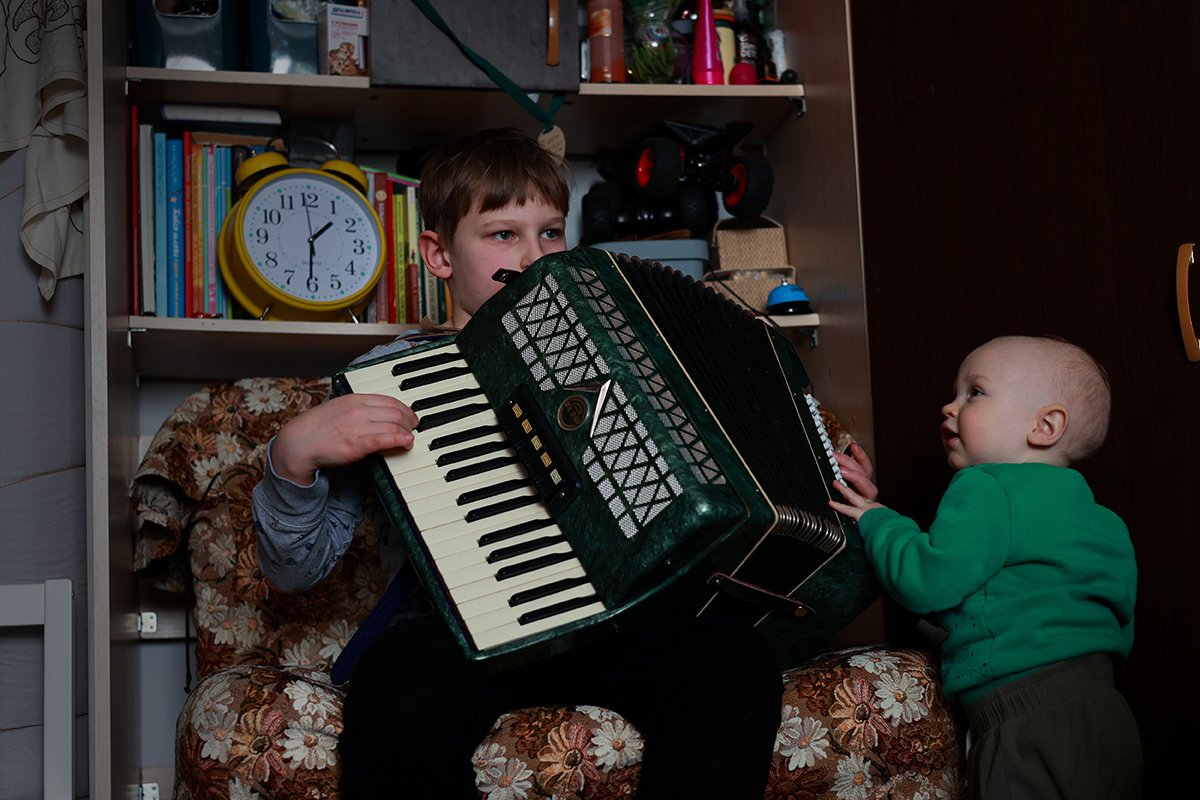 Boy playing accordion.
